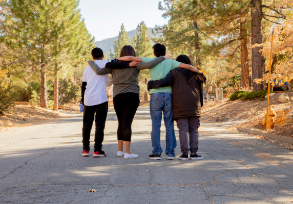 teens linked arms on road 600x400